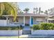 Charming home featuring a blue front door, a cozy front porch, and freshly landscaped yard at 1305 20Th W St, Bradenton, FL 34205