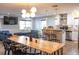 Bright open living space with a modern kitchen, dining area with rustic table, and comfortable seating at 1305 20Th W St, Bradenton, FL 34205