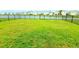 Spacious backyard featuring a black fence and views of the water at 13068 Oak Hill Way, Parrish, FL 34219