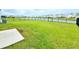Large backyard with a pond view and black metal fence at 13068 Oak Hill Way, Parrish, FL 34219
