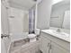 Bright bathroom featuring a shower-tub combo, modern vanity, and wood-look flooring at 13068 Oak Hill Way, Parrish, FL 34219