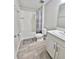 Bright bathroom featuring a shower-tub combo, modern vanity, and wood-look flooring at 13068 Oak Hill Way, Parrish, FL 34219