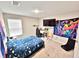 Comfortable bedroom featuring a large window, desk, and interesting decor at 13068 Oak Hill Way, Parrish, FL 34219