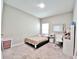 A bright bedroom with neutral colors, window, and simple decor at 13068 Oak Hill Way, Parrish, FL 34219