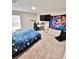 Comfortable bedroom featuring a large window, desk, and interesting decor at 13068 Oak Hill Way, Parrish, FL 34219