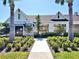Beautiful clubhouse featuring tropical landscaping, neutral paint and stone accents at 13068 Oak Hill Way, Parrish, FL 34219