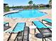 Resort-style community pool with lounge chairs and clear blue water at 13068 Oak Hill Way, Parrish, FL 34219