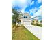 Charming two-story home with a two-car garage, complimented by a lush green lawn and mature landscaping at 13068 Oak Hill Way, Parrish, FL 34219