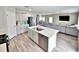 Open kitchen with a large island, stainless steel appliances, and seamless flow into the living area at 13068 Oak Hill Way, Parrish, FL 34219