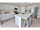 Modern kitchen with a center island, stainless steel appliances, and sleek white cabinets at 13068 Oak Hill Way, Parrish, FL 34219