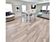 Open-concept living room with modern furnishings, a dining table, and abundant natural light from multiple windows at 13068 Oak Hill Way, Parrish, FL 34219