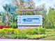 Entrance sign for the Crosswind Point community amidst lush landscaping at 13068 Oak Hill Way, Parrish, FL 34219