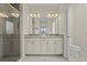 Bright bathroom features a granite countertop, double sinks, and a glass-enclosed shower at 13711 Messina Loop # 101, Bradenton, FL 34211