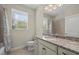 Bathroom features a granite countertop vanity, a large window, and a tiled shower at 13711 Messina Loop # 101, Bradenton, FL 34211
