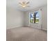 Well-lit bedroom with plush carpeting, a lighted ceiling fan, and a window view at 13711 Messina Loop # 101, Bradenton, FL 34211