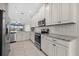 Modern kitchen with stainless steel appliances, granite counters, and white cabinetry at 13711 Messina Loop # 101, Bradenton, FL 34211