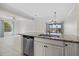 Kitchen island with stainless steel sink and granite countertops overlooking living spaces at 13711 Messina Loop # 101, Bradenton, FL 34211