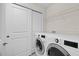 Well-equipped laundry room featuring a side-by-side washer and dryer, and shelving at 13711 Messina Loop # 101, Bradenton, FL 34211