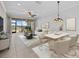 Bright living room featuring a ceiling fan, tile floors, and large sliding glass doors at 13711 Messina Loop # 101, Bradenton, FL 34211