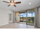 Tile floor living room showcases sliding doors to the screened in patio at 13711 Messina Loop # 101, Bradenton, FL 34211