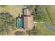 Aerial view of a home with a private pool and a long driveway surrounded by trees at 1450 & 12001 Bern Creek Loop, Sarasota, FL 34240