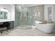 Modern bathroom with a glass shower, soaking tub, vanity with a makeup station, and neutral color palette at 1450 & 12001 Bern Creek Loop, Sarasota, FL 34240