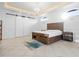 Bright bedroom with wood furnishings, a decorative chandelier, and sliding closet doors at 1450 & 12001 Bern Creek Loop, Sarasota, FL 34240