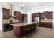 Luxury kitchen boasts custom wood cabinets, granite counters, a wine fridge, and pendant lighting at 1450 & 12001 Bern Creek Loop, Sarasota, FL 34240