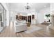 Open-concept living room featuring hardwood floors, a large sectional, and seamless access to the kitchen at 1450 & 12001 Bern Creek Loop, Sarasota, FL 34240