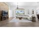 Bright living room featuring hardwood floors, large windows, and a cozy sectional sofa at 1450 & 12001 Bern Creek Loop, Sarasota, FL 34240