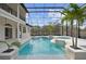 Screened-in pool and patio with a hot tub, landscaping, and plenty of space for outdoor living at 1450 & 12001 Bern Creek Loop, Sarasota, FL 34240