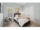 Serene bedroom with wood-look flooring, soft blue walls, and comfortable furnishings at 14817 Secret Harbor Pl, Lakewood Ranch, FL 34202