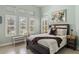 Bright bedroom offering plantation shutters, bench seating, and a soft color palette at 14817 Secret Harbor Pl, Lakewood Ranch, FL 34202