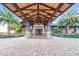 Covered porte-cochere at clubhouse with striking wood beam architectural details and stone pillars at 14817 Secret Harbor Pl, Lakewood Ranch, FL 34202