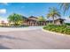Community clubhouse featuring covered entryway, manicured landscaping, and ample parking at 14817 Secret Harbor Pl, Lakewood Ranch, FL 34202