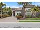 Beautiful home exterior with lush landscaping and a paver driveway at 14817 Secret Harbor Pl, Lakewood Ranch, FL 34202