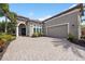 Charming home featuring a paver driveway and manicured landscaping at 14817 Secret Harbor Pl, Lakewood Ranch, FL 34202