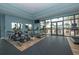 Community fitness center features treadmills and ellipticals and overlooks the outdoor area and pool at 14817 Secret Harbor Pl, Lakewood Ranch, FL 34202