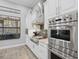 Gourmet kitchen boasts stainless steel appliances, white cabinetry, and granite countertops at 14817 Secret Harbor Pl, Lakewood Ranch, FL 34202