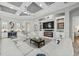 Bright living room boasts coffered ceiling, built-in fireplace, and comfortable white sectional at 14817 Secret Harbor Pl, Lakewood Ranch, FL 34202