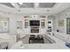 Cozy living room with built-in media center and views of the bedroom at 14817 Secret Harbor Pl, Lakewood Ranch, FL 34202