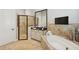 Luxurious bathroom features a soaking tub, a glass shower, and elegant tile work at 14817 Secret Harbor Pl, Lakewood Ranch, FL 34202