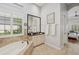 Bright bathroom offers a large soaking tub, neutral color palette, and plenty of natural light at 14817 Secret Harbor Pl, Lakewood Ranch, FL 34202