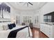 Bright and airy main bedroom with plantation shutters and a cozy seating area at 14817 Secret Harbor Pl, Lakewood Ranch, FL 34202