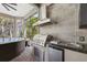 This outdoor kitchen features stainless steel appliances, a grill, and countertop space for outdoor entertaining at 14817 Secret Harbor Pl, Lakewood Ranch, FL 34202