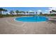Community pool with zero entry, splash pad and beach entry with lots of lounge chairs at 14817 Secret Harbor Pl, Lakewood Ranch, FL 34202
