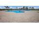 Community pool with zero entry, splash pad and beach entry with lots of lounge chairs at 14817 Secret Harbor Pl, Lakewood Ranch, FL 34202