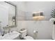 Stylish powder room with vessel sink, decorative mirror, and contemporary light fixture at 14817 Secret Harbor Pl, Lakewood Ranch, FL 34202
