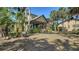 Large backyard with mature trees, lush lawn and screened-in porch, creating a serene outdoor oasis at 1533 Oak Way, Sarasota, FL 34232