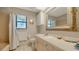 Bathroom with neutral-toned tiling and vanity with a decorative, framed mirror at 1533 Oak Way, Sarasota, FL 34232